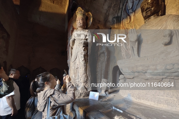 Tourists visit the Xiangtang Mountain Grottoes in Handan, China, on October 5, 2024. 