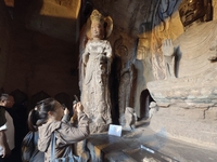 Tourists visit the Xiangtang Mountain Grottoes in Handan, China, on October 5, 2024. (