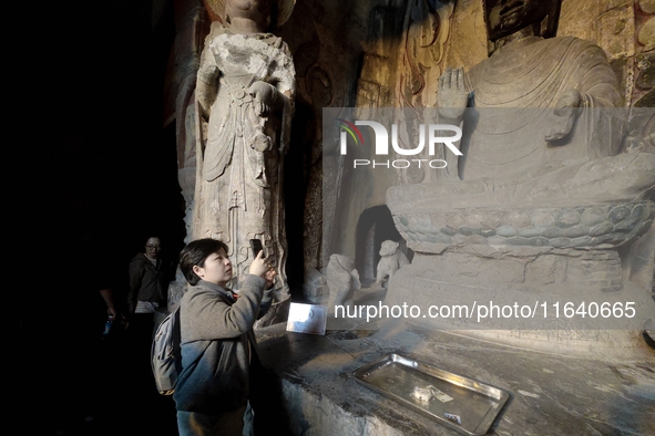 Tourists visit the Xiangtang Mountain Grottoes in Handan, China, on October 5, 2024. 