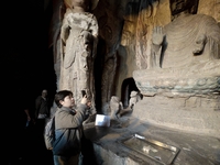 Tourists visit the Xiangtang Mountain Grottoes in Handan, China, on October 5, 2024. (