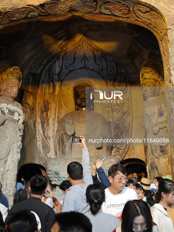 Tourists visit the Xiangtang Mountain Grottoes in Handan, China, on October 5, 2024. 