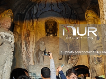 Tourists visit the Xiangtang Mountain Grottoes in Handan, China, on October 5, 2024. (