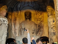 Tourists visit the Xiangtang Mountain Grottoes in Handan, China, on October 5, 2024. (