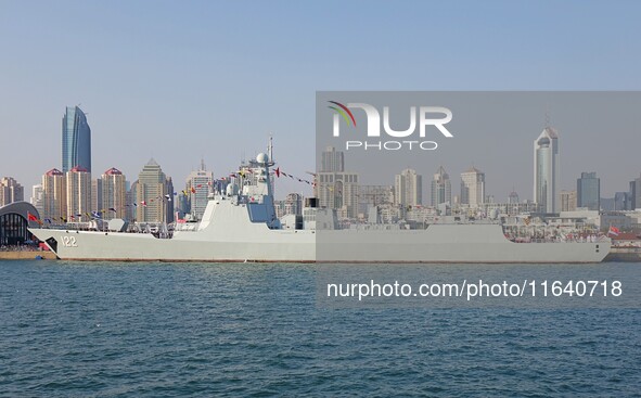 Tourists visit a warship at the port of the International Sailing Center in Qingdao, China, on October 3, 2024. 