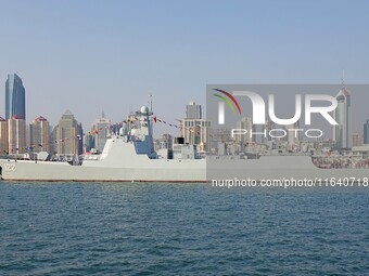 Tourists visit a warship at the port of the International Sailing Center in Qingdao, China, on October 3, 2024. (