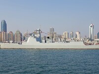 Tourists visit a warship at the port of the International Sailing Center in Qingdao, China, on October 3, 2024. (