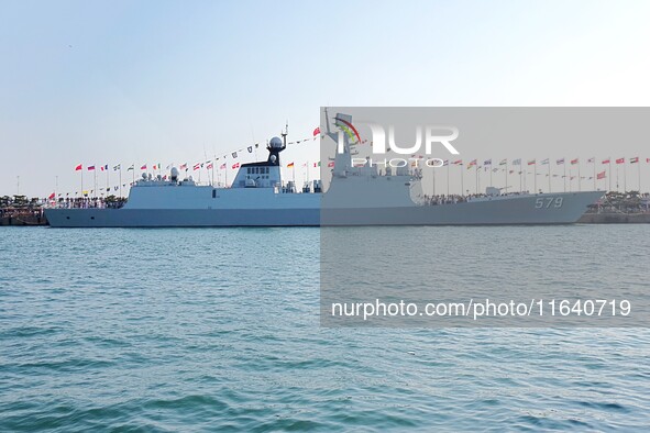 Tourists visit a warship at the port of the International Sailing Center in Qingdao, China, on October 3, 2024. 