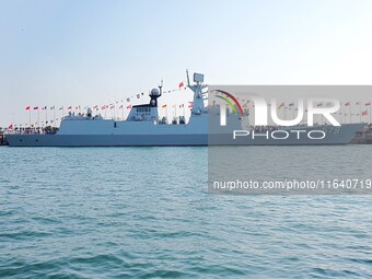 Tourists visit a warship at the port of the International Sailing Center in Qingdao, China, on October 3, 2024. (