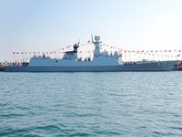 Tourists visit a warship at the port of the International Sailing Center in Qingdao, China, on October 3, 2024. (