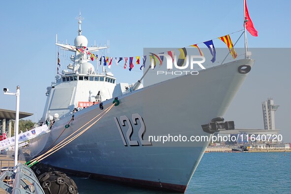 Tourists visit a warship at the port of the International Sailing Center in Qingdao, China, on October 3, 2024. 