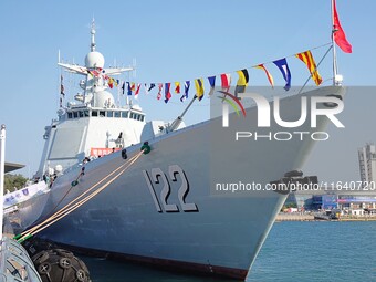 Tourists visit a warship at the port of the International Sailing Center in Qingdao, China, on October 3, 2024. (