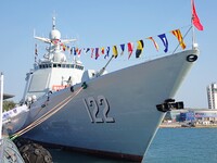 Tourists visit a warship at the port of the International Sailing Center in Qingdao, China, on October 3, 2024. (