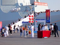 Tourists visit a warship at the port of the International Sailing Center in Qingdao, China, on October 3, 2024. (