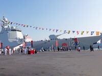 Tourists visit a warship at the port of the International Sailing Center in Qingdao, China, on October 3, 2024. (