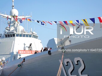 Tourists visit a warship at the port of the International Sailing Center in Qingdao, China, on October 3, 2024. (