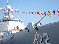 Tourists visit a warship at the port of the International Sailing Center in Qingdao, China, on October 3, 2024. (