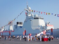 Tourists visit a warship at the port of the International Sailing Center in Qingdao, China, on October 3, 2024. (