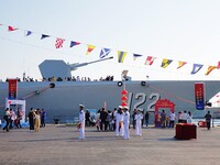 Tourists visit a warship at the port of the International Sailing Center in Qingdao, China, on October 3, 2024. (