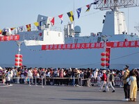 Tourists visit a warship at the port of the International Sailing Center in Qingdao, China, on October 3, 2024. (