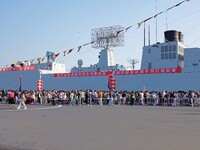 Tourists visit a warship at the port of the International Sailing Center in Qingdao, China, on October 3, 2024. (