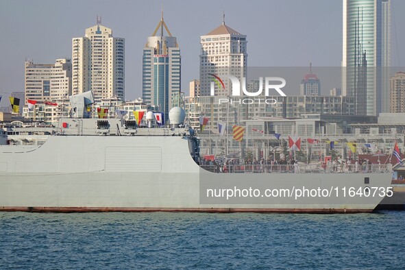 Tourists visit a warship at the port of the International Sailing Center in Qingdao, China, on October 3, 2024. 