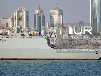 Tourists visit a warship at the port of the International Sailing Center in Qingdao, China, on October 3, 2024. (