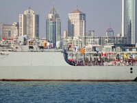 Tourists visit a warship at the port of the International Sailing Center in Qingdao, China, on October 3, 2024. (