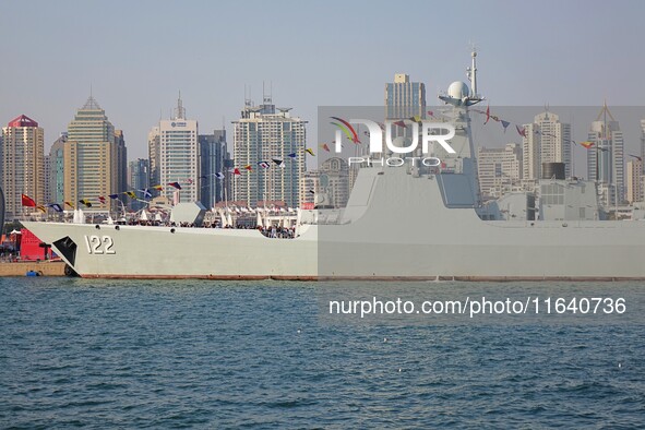 Tourists visit a warship at the port of the International Sailing Center in Qingdao, China, on October 3, 2024. 