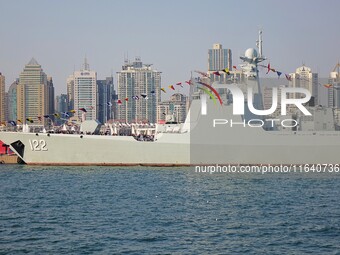 Tourists visit a warship at the port of the International Sailing Center in Qingdao, China, on October 3, 2024. (