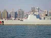 Tourists visit a warship at the port of the International Sailing Center in Qingdao, China, on October 3, 2024. (