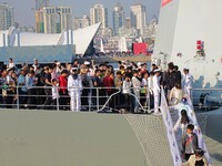 Tourists visit a warship at the port of the International Sailing Center in Qingdao, China, on October 3, 2024. (