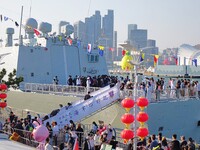 Tourists visit a warship at the port of the International Sailing Center in Qingdao, China, on October 3, 2024. (