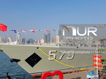 Tourists visit a warship at the port of the International Sailing Center in Qingdao, China, on October 3, 2024. (