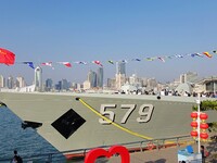 Tourists visit a warship at the port of the International Sailing Center in Qingdao, China, on October 3, 2024. (