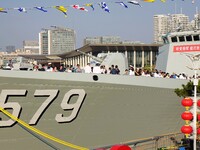 Tourists visit a warship at the port of the International Sailing Center in Qingdao, China, on October 3, 2024. (