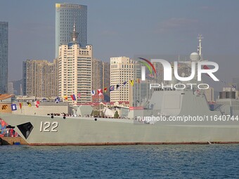 Tourists visit a warship at the port of the International Sailing Center in Qingdao, China, on October 3, 2024. (