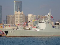 Tourists visit a warship at the port of the International Sailing Center in Qingdao, China, on October 3, 2024. (