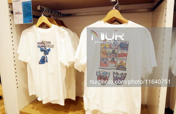 Transformers x UNIQLO co-branded custom T-shirts are displayed at the Uniqlo flagship store in Shanghai, China, on October 4, 2024. This yea...