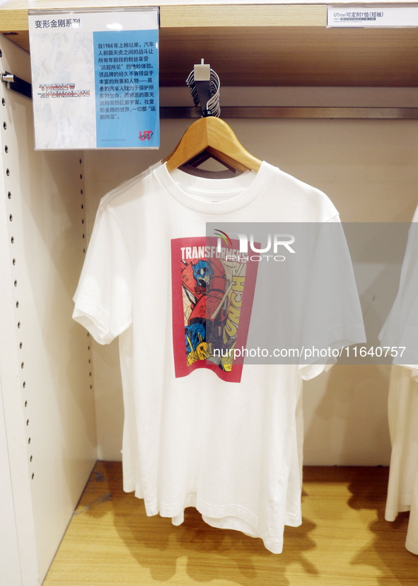 Transformers x UNIQLO co-branded custom T-shirts are displayed at the Uniqlo flagship store in Shanghai, China, on October 4, 2024. This yea...