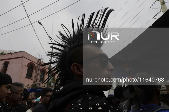 A young man attends a concert during the 44th anniversary of the Tianguis Cultural del Chopo in Mexico City, Mexico, on October 5, 2024, a p...