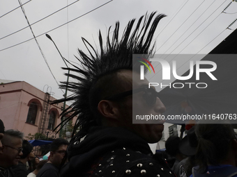 A young man attends a concert during the 44th anniversary of the Tianguis Cultural del Chopo in Mexico City, Mexico, on October 5, 2024, a p...