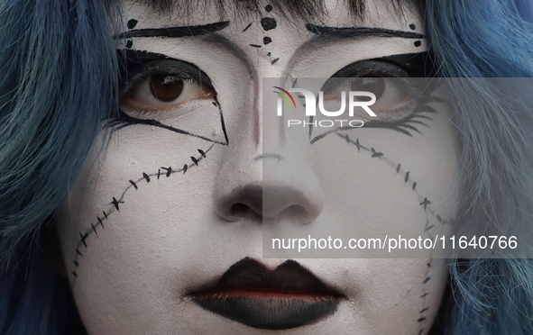 A woman poses for a portrait during a concert on the occasion of the 44th anniversary of the Tianguis Cultural del Chopo in Mexico City, Mex...