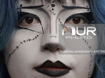 A woman poses for a portrait during a concert on the occasion of the 44th anniversary of the Tianguis Cultural del Chopo in Mexico City, Mex...