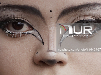 A woman poses for a portrait during a concert on the occasion of the 44th anniversary of the Tianguis Cultural del Chopo in Mexico City, Mex...