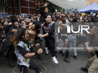 Young people dance during a concert to mark the 44th anniversary of the Tianguis Cultural del Chopo in Mexico City, Mexico, on October 5, 20...