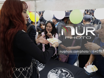 Cake is distributed during a concert on the occasion of the 44th anniversary of the Tianguis Cultural del Chopo in Mexico City, Mexico, on O...