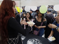 Cake is distributed during a concert on the occasion of the 44th anniversary of the Tianguis Cultural del Chopo in Mexico City, Mexico, on O...