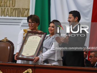 Clara Brugada Molina receives the certificate that endorses her as Head of Government of Mexico City during the swearing-in ceremony at the...