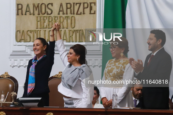 Claudia Sheinbaum Pardo, the first female President of Mexico, lifts the hand of incoming Mexico City Head of Government Clara Brugada Molin...