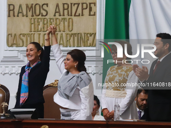 Claudia Sheinbaum Pardo, the first female President of Mexico, lifts the hand of incoming Mexico City Head of Government Clara Brugada Molin...